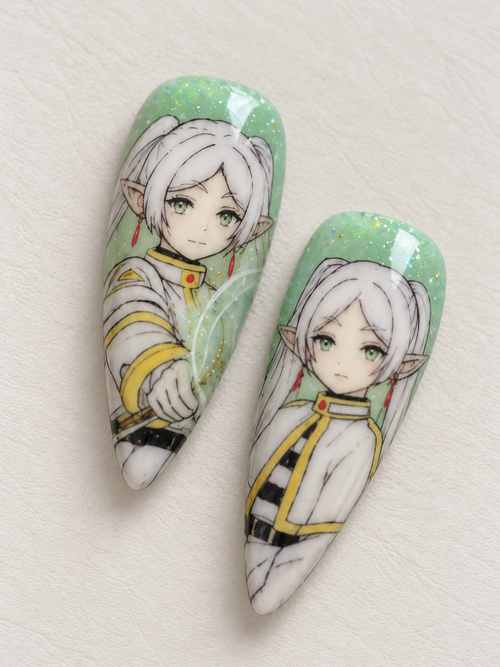 Close-up of Frieren character nail art with sparkling green background